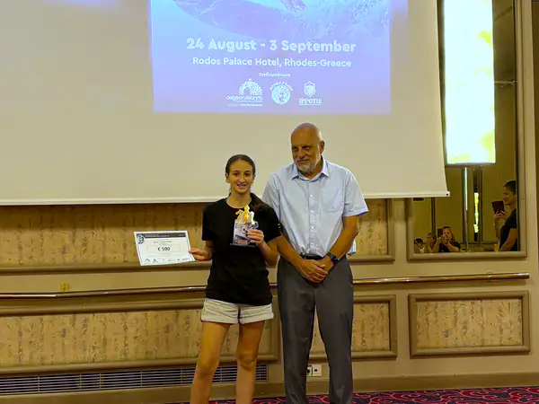 A young award recipient with her trophy
