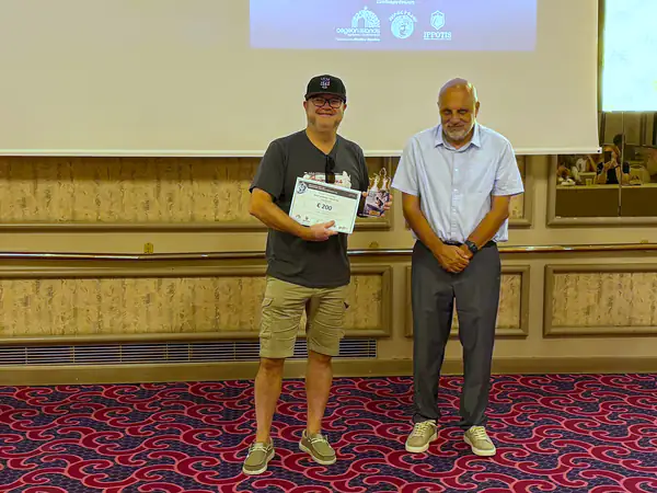 An award recipient with his certificate and trophy