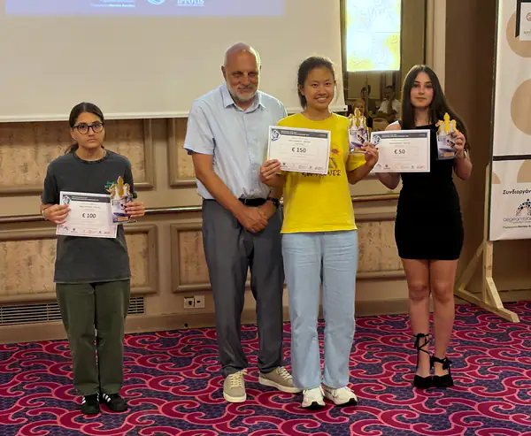 Three award recipients with their certificates and trophies